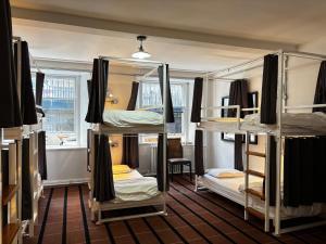 a room with three bunk beds in it at Safestay Glasgow Charing Cross in Glasgow