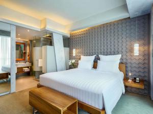 Voodi või voodid majutusasutuse Pullman Jakarta Central Park toas