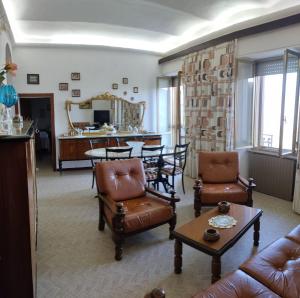 a living room with a couch and chairs and a table at Casa Felice in Tirli