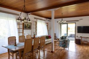 a dining room and living room with a table and chairs at Gyra Villas - Villa Ermis with private pool in Lefkada