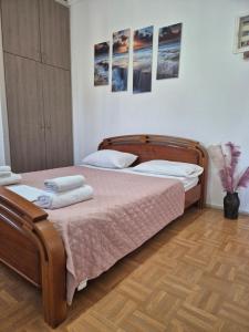 a bedroom with two beds and a wooden floor at Urban Roof Studio in Kavala