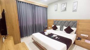 Postel nebo postele na pokoji v ubytování Hotel Suncity