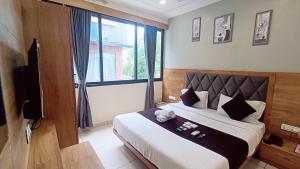 Postel nebo postele na pokoji v ubytování Hotel Suncity