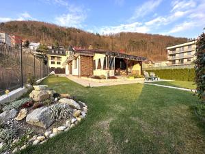 a yard with a house and a building at Family House Teplice in Trenčianske Teplice