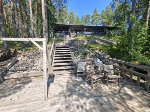 a staircase leading to a house in the woods at Lake side villa 206m2 Sastamala 