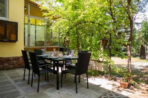 a table and chairs sitting on a patio at Arany Toboz Vendégház in Siófok +6 photos