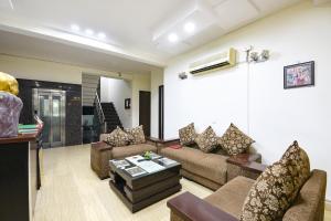 a living room with a couch and a table at Gazelle Inn in Gurgaon