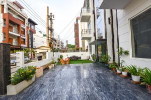 an empty courtyard of a building with potted plants at Gazelle Inn in Gurgaon