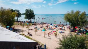 a large crowd of people on a beach at Houseboats Dollar - Plaża Nowe Guty in Nowe Guty