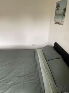 a bed in a corner of a room at ComfortVilla in Hornchurch