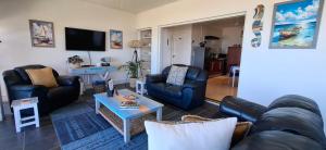 a living room with a couch and chairs and a table at Tweede Wind in Yzerfontein