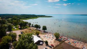 a group of people on a beach in the water at Houseboats Dollar - Plaża Nowe Guty in Nowe Guty +7 photos