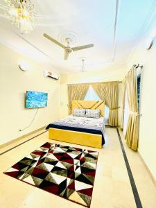 a bedroom with a bed and a rug on the floor at Ayyan Cottage G 10-2 in Islamabad