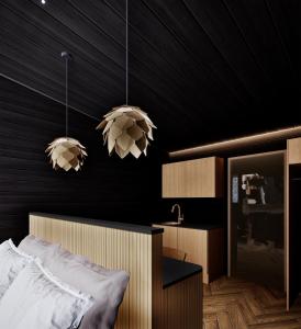 Ένα ή περισσότερα κρεβάτια σε δωμάτιο στο Lapland Glow Hotel Chalets