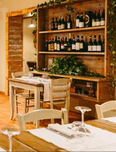 a dining room with a table and bottles of wine at La rupe dei gabbiani in Terracina