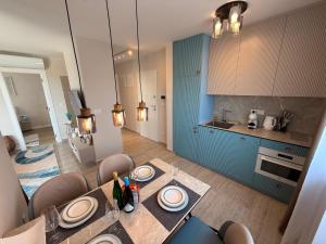 a kitchen with a table and chairs in a room at Ferula apartment Vir in Vir