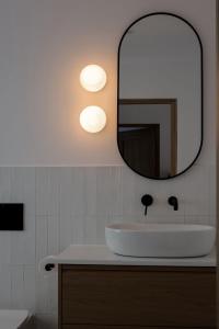 a bathroom with a sink and a mirror at Leśne Chatki - Apartamenty Świerk i Sosna in Koniaków +10 photos