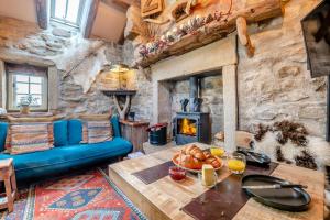a living room with a table and a fireplace at Woolcombers in Addingham