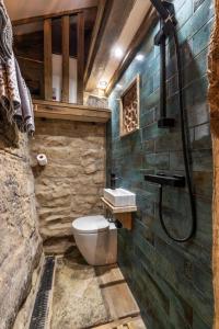 a bathroom with a toilet and a shower at Woolcombers in Addingham