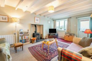 a living room with a couch and a table at Butlers Cottage in Hardraw