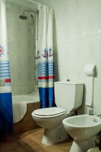 a bathroom with a toilet and a shower curtain at Hospederia del Comendador in Ocaña