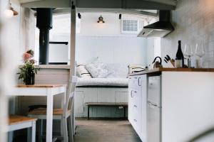 a kitchen with a couch in a small room at Little Vineyard Caboose in Drummond +15 photos