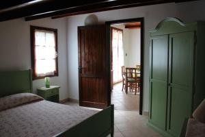 a bedroom with a bed and a dining room at Albatros in Capoterra