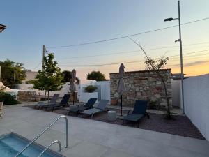 a group of chairs and a pool in a yard at Vila Alaris Vama Veche in Vama Veche +53 photos
