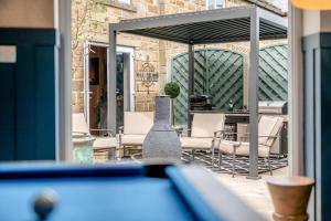 a patio with chairs and a table and ailion at Johns Cottage in Hampsthwaite