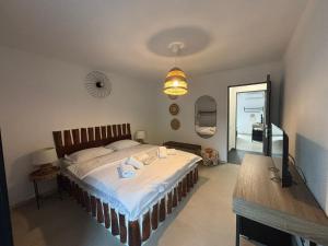 a bedroom with a bed and a table in it at Vila Alaris Vama Veche in Vama Veche