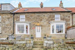 a stone house with a red roof at Red Briar House in Danby