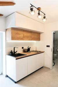 a kitchen with white cabinets and a sink at NEW! Oldie but goldie in Split +13 photos