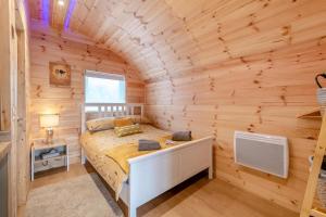 a bedroom with a bed in a wooden cabin at Woody in East Cowton