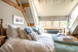a bedroom with a white bed in front of a window at Green Cottage in Robin Hood's Bay