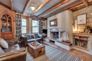 a living room with a couch and a fireplace at Green Cottage in Robin Hood's Bay