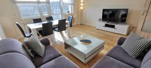 a living room with a couch and a table at Horizon Lu Apartment by the Sea in Sopot