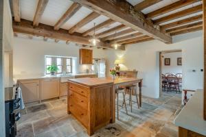 a kitchen with a wooden island in a room at High Stubbing Farm in Cowling