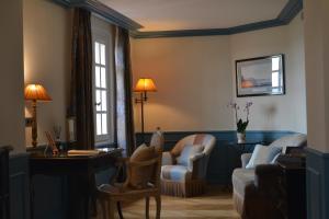 a living room with a couch and chairs and a table at Hotel Le Saint Paul in Saint Paul de Vence
