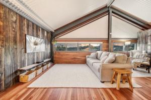 a living room with a couch and a table at Linden Rose Barn in Montville