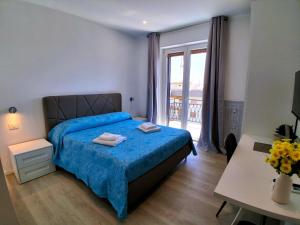 a bedroom with a bed and a window and a desk at Virgy White rooms in Bari