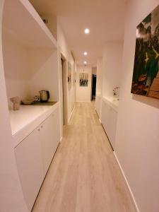 a hallway with white cabinets and a long hallway with a hallway at Virgy White rooms in Bari