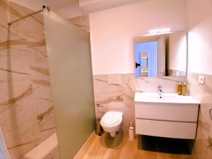 a bathroom with a toilet and a sink and a mirror at Virgy White rooms in Bari