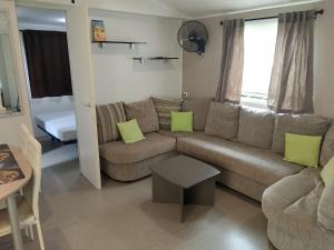 a living room with a couch and a table at Domaine De Dugny in Veuzain-sur-Loire