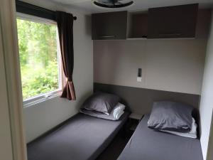 two beds in a room with a window at Domaine De Dugny in Veuzain-sur-Loire +20 photos