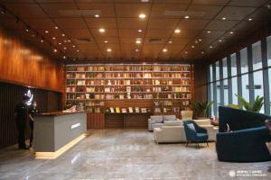 a lobby with a library with couches and books at LOTUS BLU HOTEL Naga 
