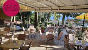 a restaurant with tables and chairs and a sign at Hotel Vila Ružica- glavna zgrada i depandanse in Crikvenica +110 photos