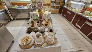 a table in a kitchen with bottles and dishes on it at Hotel Vila Ružica- glavna zgrada i depandanse in Crikvenica