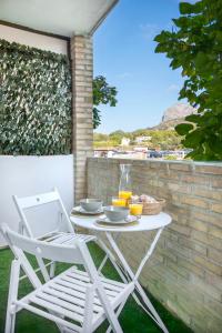 een witte tafel en stoelen op een patio bij Estancia Mar y Montaña in Jávea