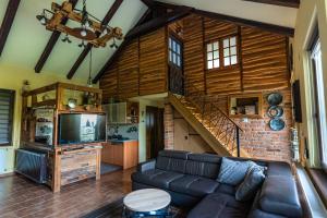 a living room with a couch and a staircase at Vila Cherry in Tuheljske Toplice