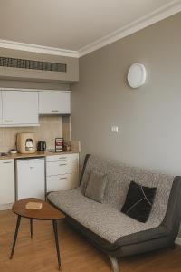 a living room with a couch and a table at מגדל אלמוג חיפה - דירות "בלו ביץ'" על הים in Haifa +32 photos